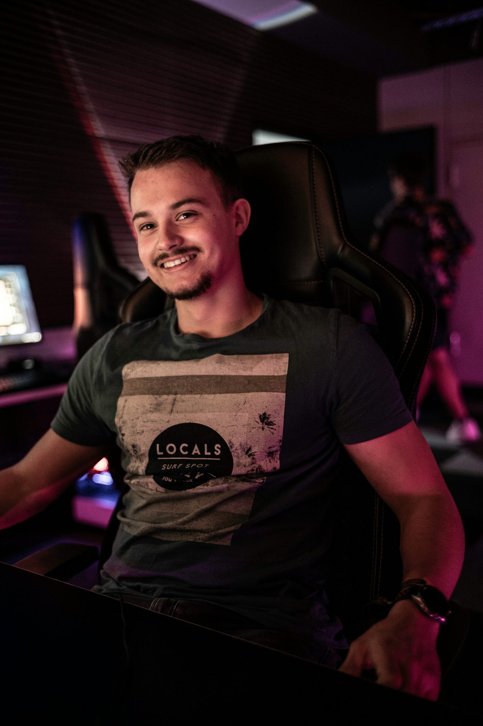 A man sitting in front of a computer desk